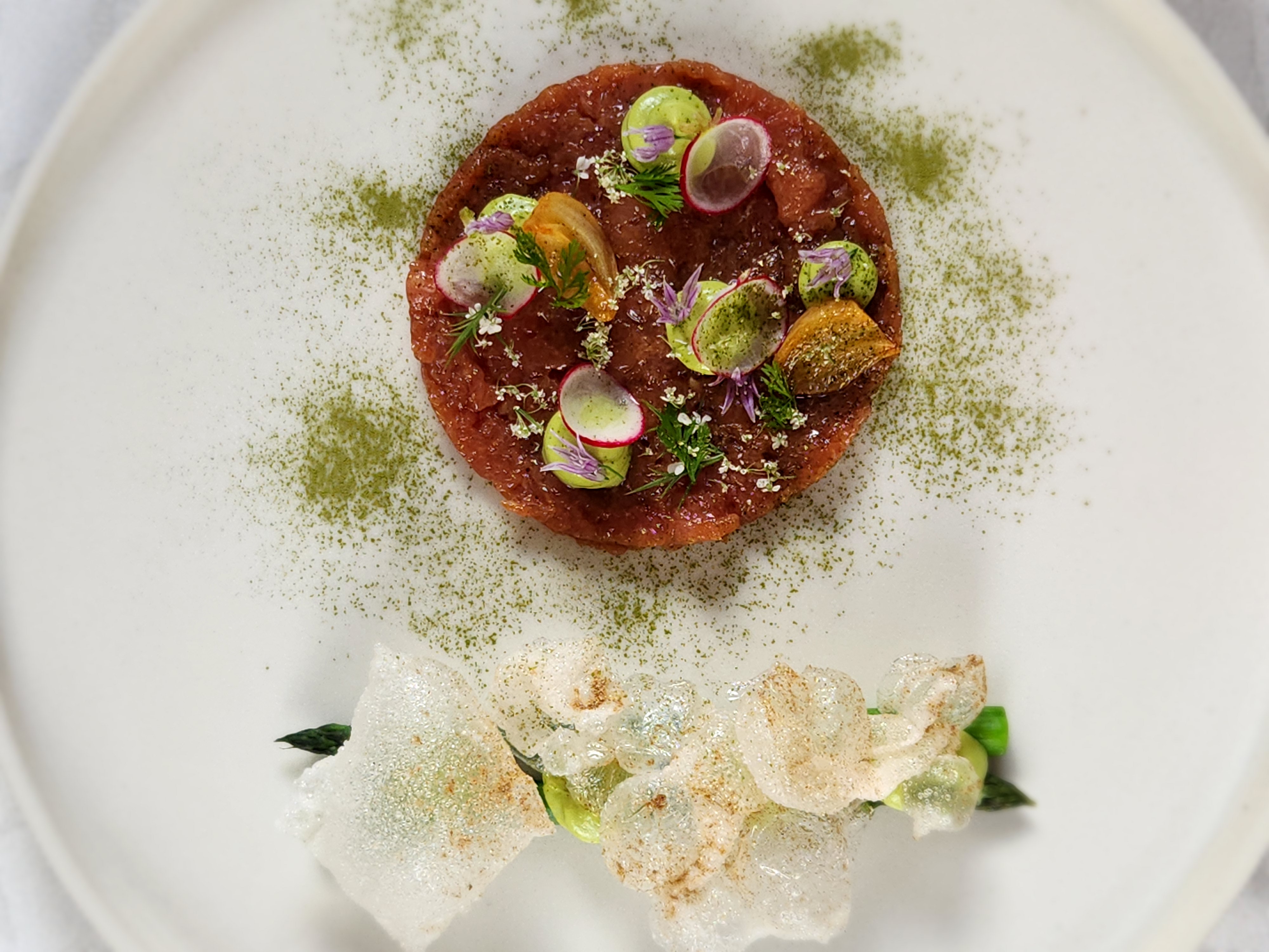Plated vegetable course with delicate garnish work
