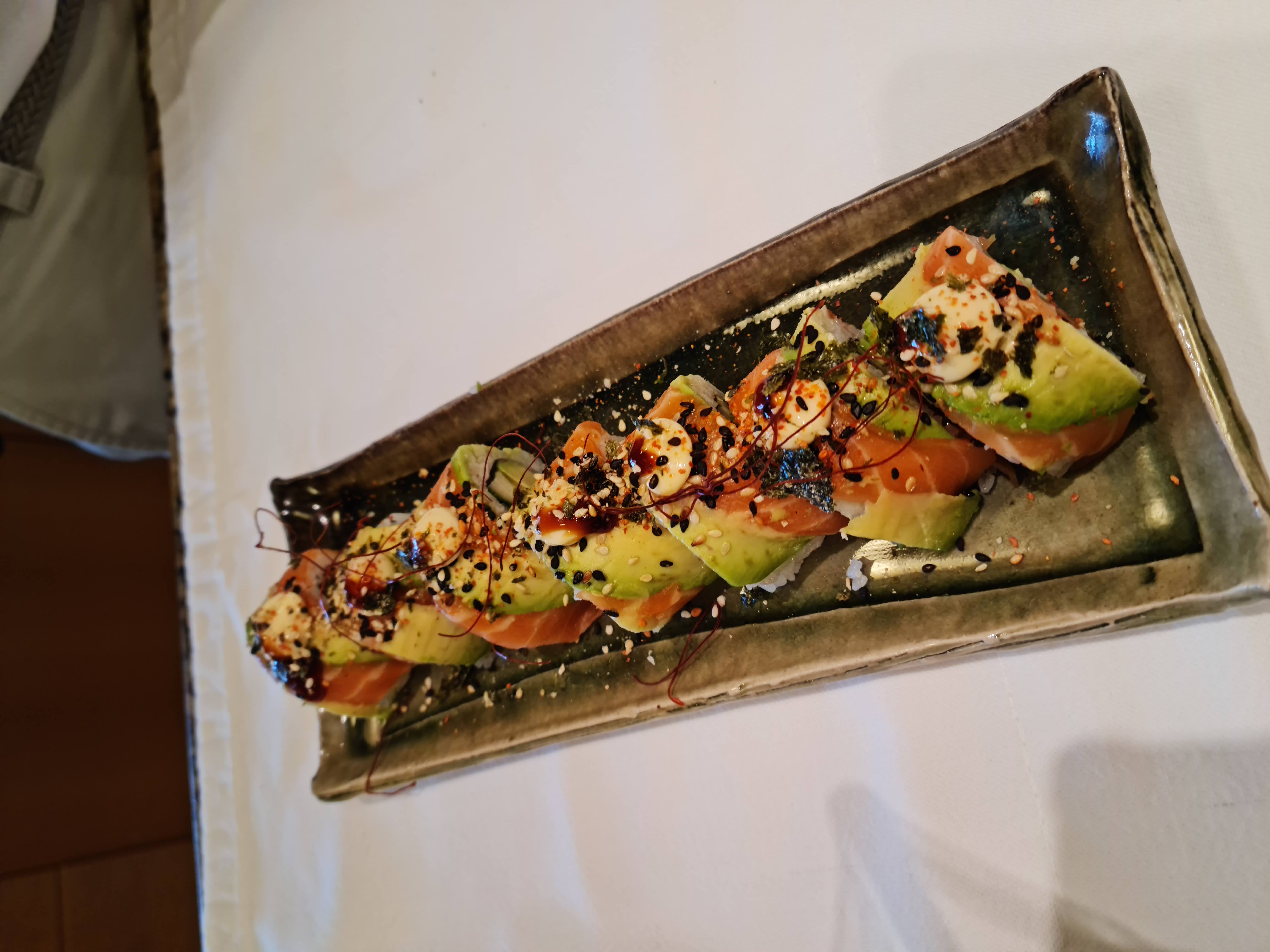 Rainbow roll layered with sashimi and finished with spicy kewpie